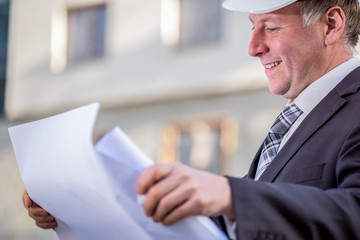 Construction manager with blueprints