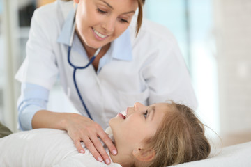 Fototapeta premium Doctor checking on child's ear