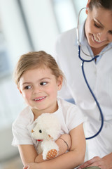 Doctor examining little girl with stethoscope
