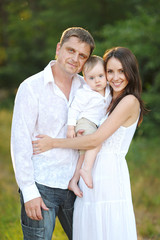 Fototapeta premium portrait of a happy family in summer nature