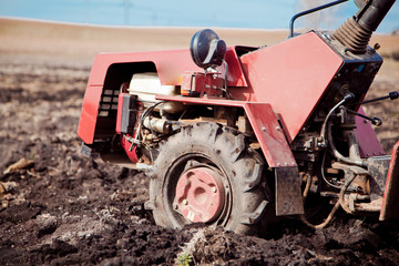 Little tractor a field in the spring  © Smart Future