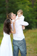 portrait of a happy family in summer nature