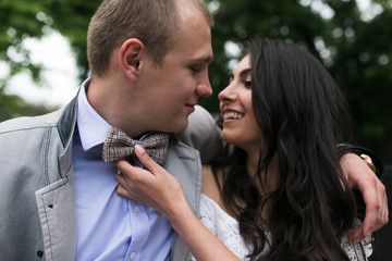 Young European couple cuddling on a park bench