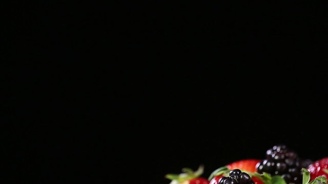 Fresh tasty berries on black background