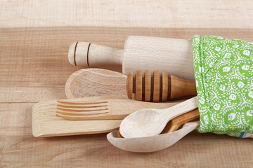 Set of kitchen utensils on wooden board.