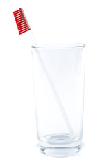 Toothbrush in a glass on a white background.