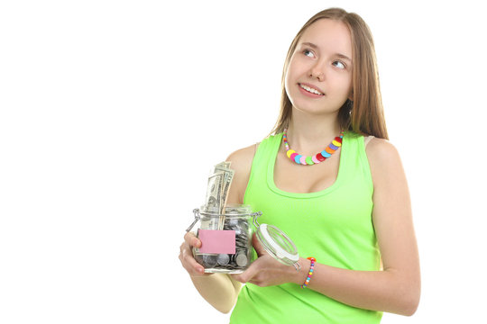 An attractive young woman holds up a bag of money while