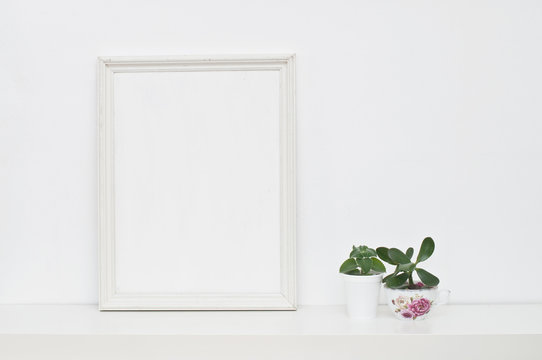 Empty picture frame and flowers