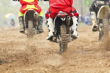 Fototapeten motocross racer accelerating speed in track © toa555