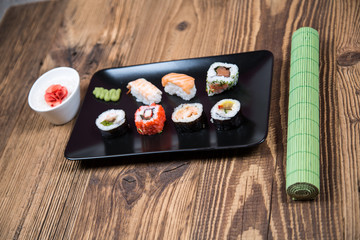 fresh Japanese tasty sushi roll set with chopsticks on wooden table