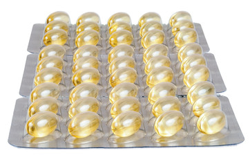 Cod liver oil capsules on white background