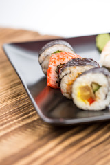 fresh Japanese tasty sushi roll set with chopsticks on wooden ta