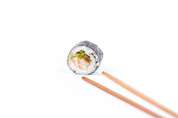 Fototapeta na wymiar fresh Japanese tasty sushi roll set with chopsticks on wooden table