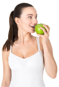 Portrait of young attractive woman eating green apple. 