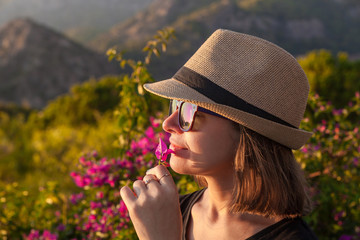 Young woman in a hat with flowers