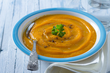 Carrot cream soup with spices and parsley