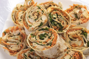 Rolls with carrots meat chicken and greens.