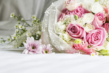 Bouquet on the bed in bedroom
