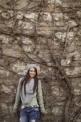 Young woman by the wall