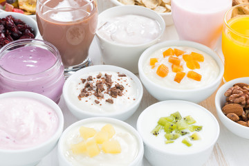 Assorted fresh fruit yoghurts and breakfast ingredients