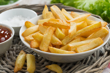 fried french fries with tomato sauce, close-up