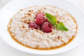 oatmeal with fresh raspberries and honey, close-up