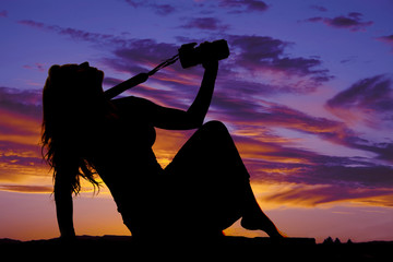 silhouette of a woman with a camera sitting head back