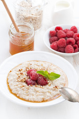 oatmeal with raspberries and honey, vertical
