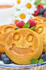 smiling tasty corn pancake with berries