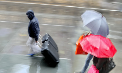 people shopping in the cityin rainy weather  motion blur