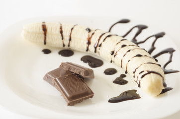 Banana with chocolate bars and topping