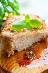 Bright photo of baked meat with basil leaf