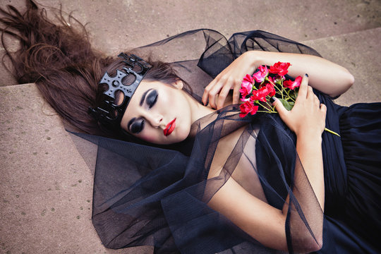 Dark Lying Queen In Veil With Red Flower Und Closed Eyes