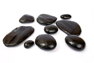 Black wet stones on white background