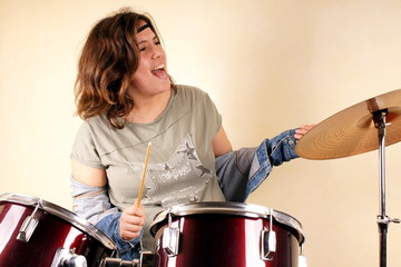 Studio shot of a young lady on drums