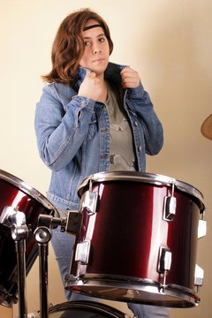Studio shot of a young lady on drums