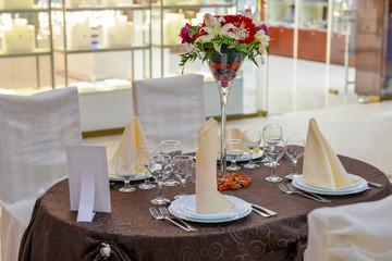 Wedding table arranged with bunch of flowers
