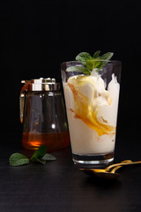 ice cream in a glass with honey on a dark
