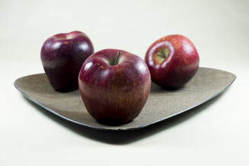 Red apples on a plate