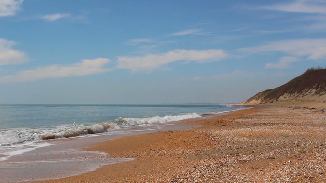 light waves at the sea coast in sunny spring day