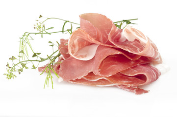 Italian prosciutto crudo ,raw ham leg sliced on white