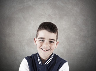 portrait of smiling boy on background