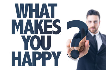 Business man pointing the text: What Makes You Happy?