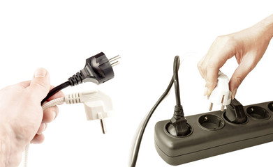 The process of connecting different plugs into a wall outlet