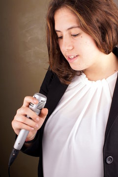 Studio shot of a young lady with microphone