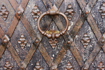 fragment of an ancient metal door with handle