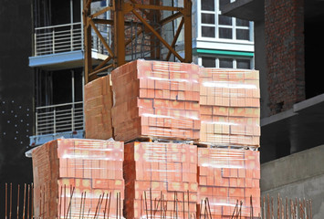 Stack of red clay brick on construction site