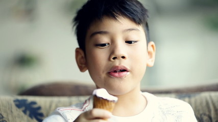 Little asian cute boy enjoy eating an ice cream