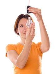 Fototapeta premium girl change a light bulb