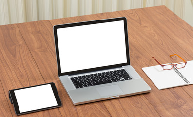 Blank screen laptop computer with office accessories on wooden t